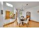 Dining area with a round table, wood floors, a chandelier, a staircase, and natural light from large windows at 766 Chimney Creek Dr, Golden, CO 80401