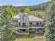 A gorgeous view of the home's exterior, showcasing its elegant design and large deck at 766 Chimney Creek Dr, Golden, CO 80401