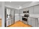 Kitchen with stainless steel appliances and gray cabinets at 766 Chimney Creek Dr, Golden, CO 80401