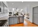 Open concept kitchen with granite counters, fireplace, skylights, and stainless steel dishwasher at 766 Chimney Creek Dr, Golden, CO 80401