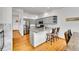 Kitchen with gray cabinets, stainless steel appliances, hardwood floors, and breakfast bar seating at 766 Chimney Creek Dr, Golden, CO 80401