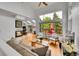 Bright living room featuring high ceilings, large windows, wood floors, a ceiling fan, and a fireplace at 766 Chimney Creek Dr, Golden, CO 80401