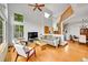 Open-concept living room featuring wood floors, high ceilings, large windows, and a staircase to the second floor at 766 Chimney Creek Dr, Golden, CO 80401