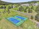 Aerial view of community tennis courts surrounded by lush greenery at 766 Chimney Creek Dr, Golden, CO 80401