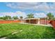 Spacious backyard with lush green grass, a patio, and a fence at 3216 Revere St, Aurora, CO 80011