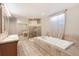 Spacious bathroom with a corner shower, jacuzzi tub, and tiled floor at 3216 Revere St, Aurora, CO 80011