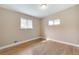Bright bedroom with hardwood floors, neutral paint, and natural light from two windows at 3216 Revere St, Aurora, CO 80011