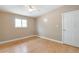 Spacious bedroom with a ceiling fan, hardwood floors, and a large window at 3216 Revere St, Aurora, CO 80011