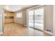 Open layout from dining to kitchen area featuring wood cabinets and a sliding door to the backyard at 3216 Revere St, Aurora, CO 80011