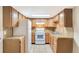 Well-lit kitchen featuring wooden cabinets and white appliances at 3216 Revere St, Aurora, CO 80011