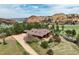 Stunning aerial view showcasing the home's serene setting with mountain views, mature trees, and lush lawn at 5565 Osage Way, Larkspur, CO 80118