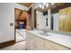 Bathroom with a modern vanity, stylish lighting, and an open doorway to the game room at 5565 Osage Way, Larkspur, CO 80118