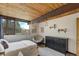 Comfortable bedroom with natural light, stylish furniture, and an attractive view of the outdoors at 5565 Osage Way, Larkspur, CO 80118