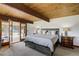 Spacious bedroom with wood beam ceiling and outdoor access at 5565 Osage Way, Larkspur, CO 80118