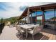 Outdoor deck with seating area and mountain views at 5565 Osage Way, Larkspur, CO 80118