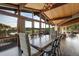 Bright dining room featuring wood paneled ceiling, large windows, and seamless flow into the outdoor deck area at 5565 Osage Way, Larkspur, CO 80118