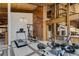 Bright exercise room with wood accents and various workout machines at 5565 Osage Way, Larkspur, CO 80118
