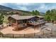 Expansive home featuring a large deck with stunning mountain views at 5565 Osage Way, Larkspur, CO 80118