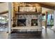 Close-up of the impressive stone fireplace with mantel and hearth at 5565 Osage Way, Larkspur, CO 80118