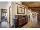 Elegant hallway featuring dark hardwood floors, stylish console, designer lighting, and access to other rooms at 5565 Osage Way, Larkspur, CO 80118