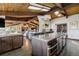 Open-concept kitchen with stainless steel appliances, granite counters, and ample cabinet space. Vaulted ceilings at 5565 Osage Way, Larkspur, CO 80118