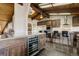 Updated kitchen with modern appliances, center island, breakfast bar, and views into the connecting rooms at 5565 Osage Way, Larkspur, CO 80118