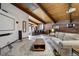 Open-concept living room and kitchen perfect for gatherings, featuring wood paneled ceilings and a large movie screen at 5565 Osage Way, Larkspur, CO 80118