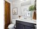 Elegant bathroom featuring a vanity with a dark wood finish, contemporary fixtures, and stylish shower curtain at 22385 E 6Th Ave, Aurora, CO 80018