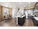 Modern kitchen with a center island that flows into a dining and seating area at 22385 E 6Th Ave, Aurora, CO 80018