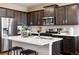 Modern kitchen with stainless steel appliances and a white center island at 22385 E 6Th Ave, Aurora, CO 80018