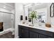 Contemporary bathroom with a double sink vanity and glass-enclosed shower at 22385 E 6Th Ave, Aurora, CO 80018