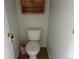 A small half bathroom featuring a toilet and a small garbage can at 1216 S Flat Rock Cir, Aurora, CO 80018