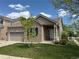 Charming brick home featuring a well-manicured lawn, mature tree, and an attached two-car garage at 1216 S Flat Rock Cir, Aurora, CO 80018