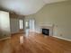 Spacious living room with a fireplace, hardwood floors, vaulted ceiling, and an abundance of natural light at 1216 S Flat Rock Cir, Aurora, CO 80018
