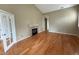 A light-filled living room showcases hardwood floors, a fireplace, and access to another room through french doors at 1216 S Flat Rock Cir, Aurora, CO 80018