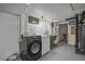 Basement laundry area with newer washer and dryer, utility sink, and storage at 903 Poplar St, Denver, CO 80220