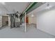 Spacious unfinished basement with painted floor and walls, showcasing mechanical systems at 903 Poplar St, Denver, CO 80220