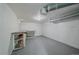 Unfinished basement area with painted walls, concrete floor, and built-in shelving at 903 Poplar St, Denver, CO 80220