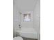 Full bathroom features a white tub with subway tile surround and modern fixtures at 903 Poplar St, Denver, CO 80220