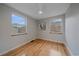 Bright bedroom with hardwood floors, neutral walls, and natural light from two windows at 903 Poplar St, Denver, CO 80220