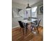 Cozy dining area featuring a marble table, modern chairs, and natural light from a nearby window at 903 Poplar St, Denver, CO 80220