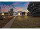 Charming single-story home featuring a well-manicured lawn and inviting facade under a colorful twilight sky at 903 Poplar St, Denver, CO 80220