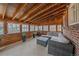 Relaxing sunroom with wood paneling, plenty of windows, and comfortable seating arrangements at 903 Poplar St, Denver, CO 80220