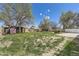 View of backyard with trees and grass; a shed is visible behind a fence at 12333 Edwards Pl, Denver, CO 80239