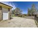 Backyard showcasing a concrete patio and shed, with a door to the side of the house at 12333 Edwards Pl, Denver, CO 80239