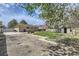 Backyard view with a mix of grass and gravel, a detached garage, and a shed at 12333 Edwards Pl, Denver, CO 80239
