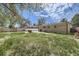 View of the backyard, featuring a grass area and the brick exterior of the house at 12333 Edwards Pl, Denver, CO 80239