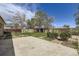 View of the backyard with grass, shed, trees, and concrete patio at 12333 Edwards Pl, Denver, CO 80239