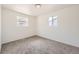 Well-lit bedroom with neutral carpet and two windows at 12333 Edwards Pl, Denver, CO 80239