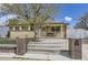 Charming brick home with a well-manicured front yard and a gated entryway at 12333 Edwards Pl, Denver, CO 80239